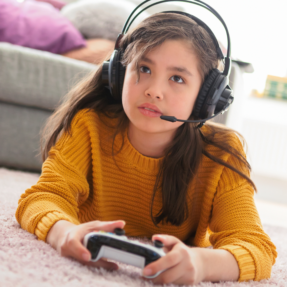 A girl playing with on an xbox and controller